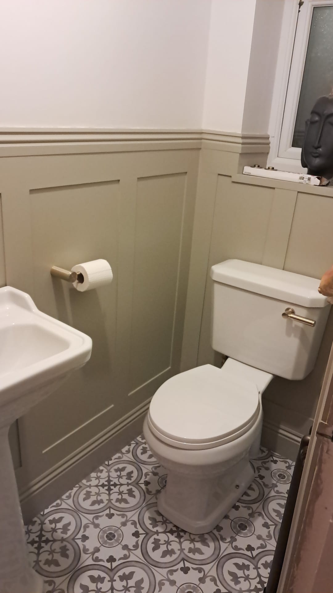 Completed bathroom with panelling and patterned floor tiles