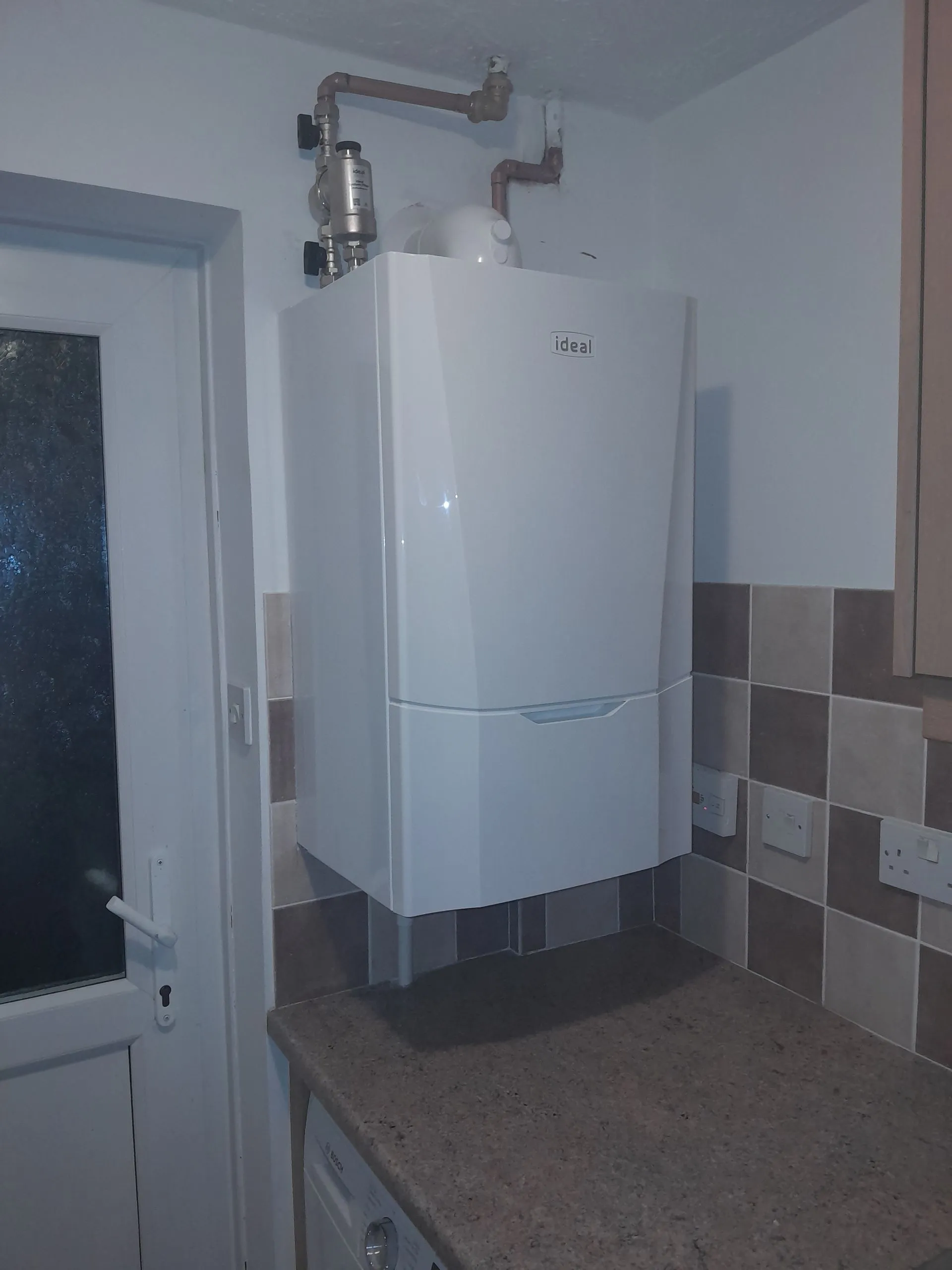 Serviced wall-mounted boiler in a tiled kitchen