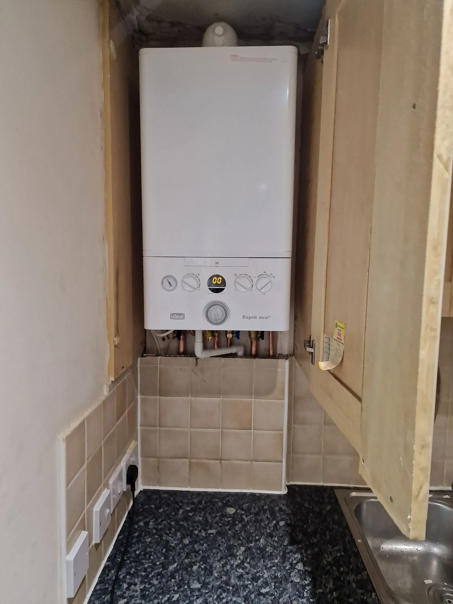 New combi boiler installation in a utility cupboard
