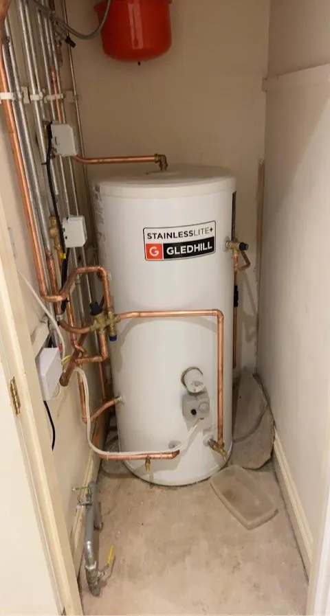 Hot water cylinder fitted in an airing cupboard