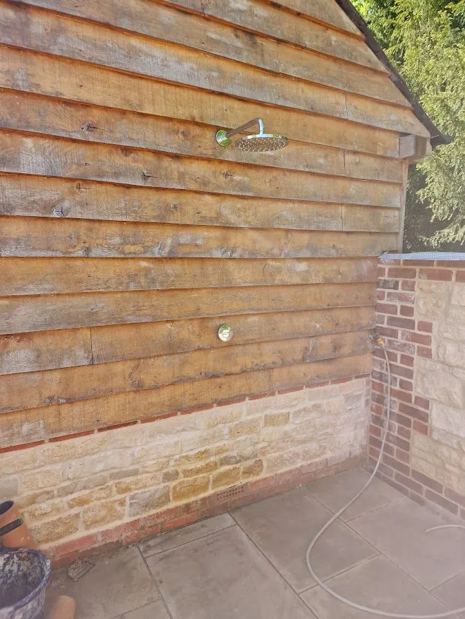 External pipework installation on a timber outbuilding