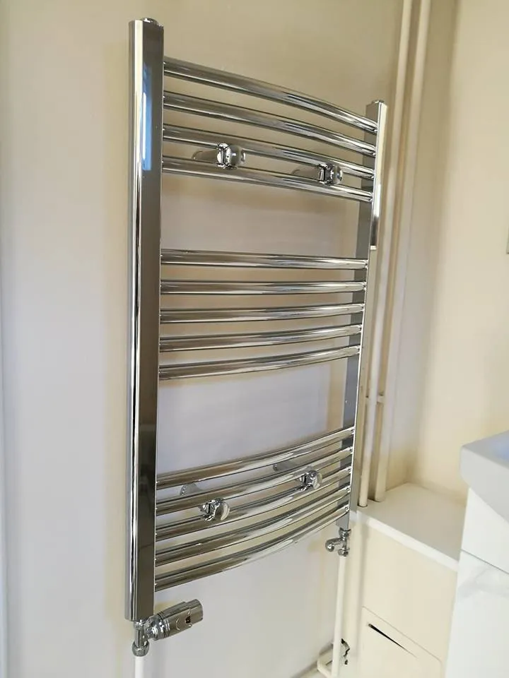 Chrome heated towel rail installed in a bathroom